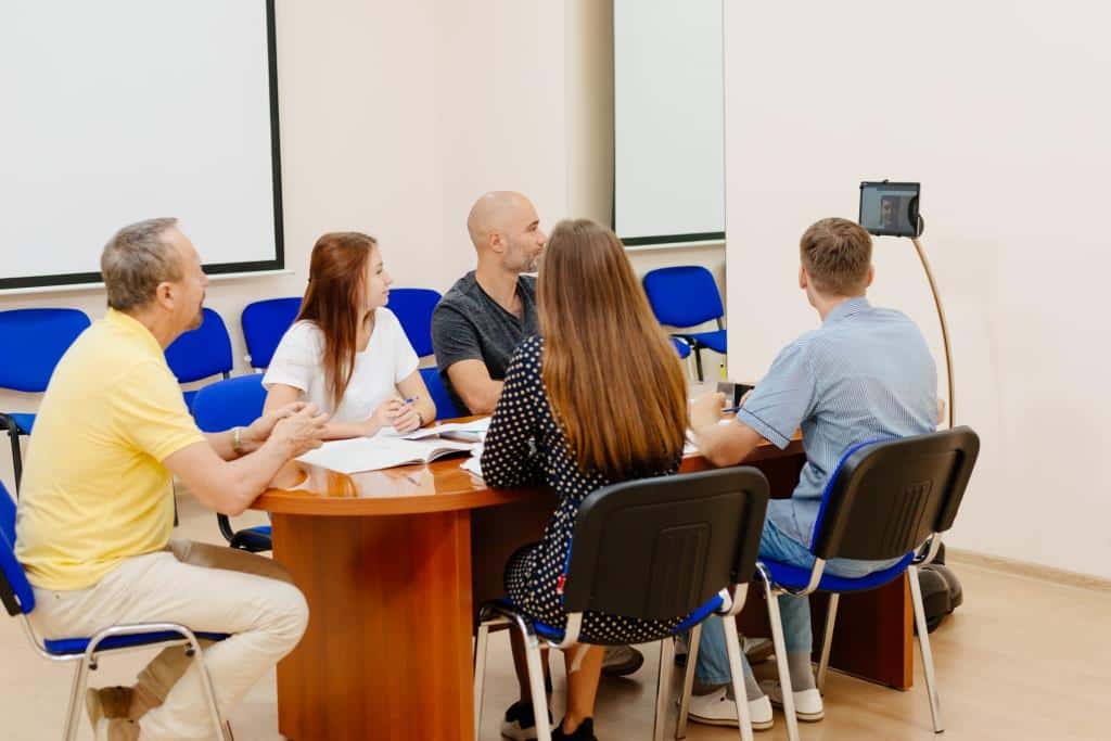 Business meeting using Telepresence robot, one of attendies is presented remotely