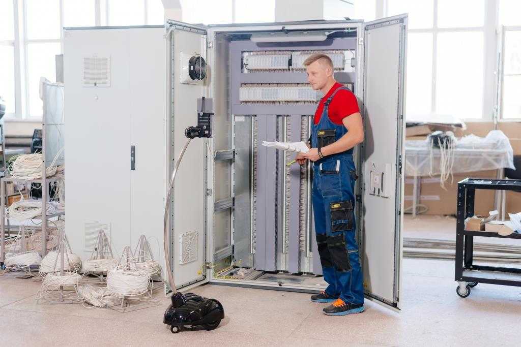 Telepresence robot looks at worker and electric case assemly